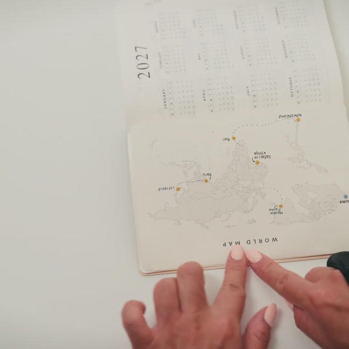 Opening a World map tip-in beside the 2027 calendar page