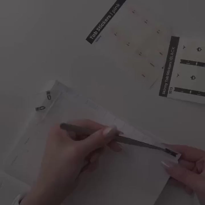 Running a finger down the finished tabs on a planner